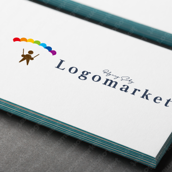 パラグライダーと虹とテイクオフのロゴ
