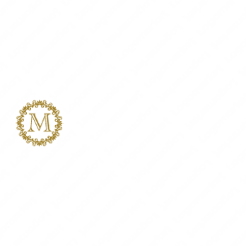 「M」とエンブレムと飾り罫のロゴ