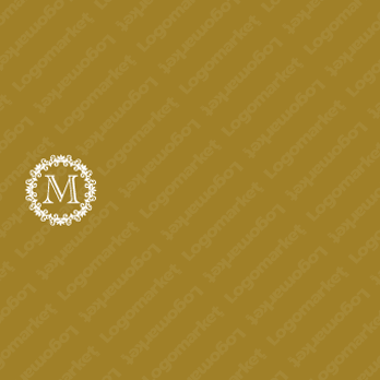 「M」とエンブレムと飾り罫のロゴ